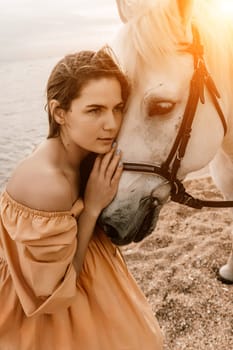 A woman in a dress stands next to a white horse on a beach, with the blue sky and sea in the background