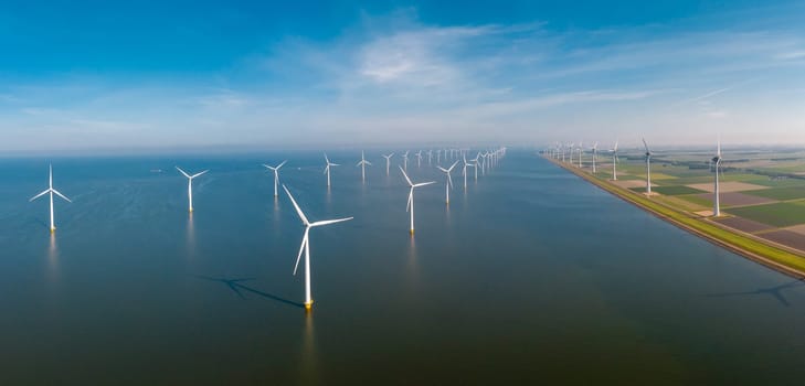 drone view at ocean Wind Farm. Windmill farm in the ocean. Offshore wind turbines in the sea. Wind turbine from an aerial view,