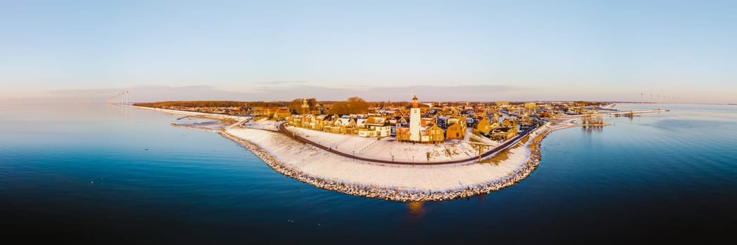 panoramic view at the Lighthouse of Urk Netherlands during sunset in the Netherlands during winter cold weather with snow