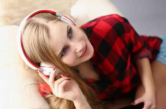 blond young pretty woman listen music headphones dream relax concept