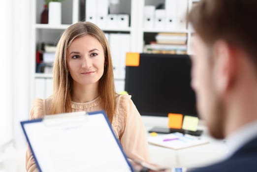 Smiling woman offer contract form on clipboard pad and silver pen to sign closeup. Strike a bargain for profit white collar motivation union decision corporate sale insurance agent concept