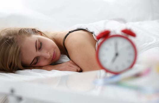 Young beautiful woman sleep well in the morning alarm concept