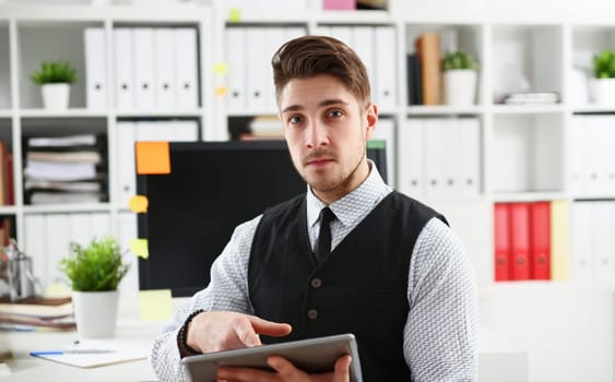 View of businessman hold tablet in hand office