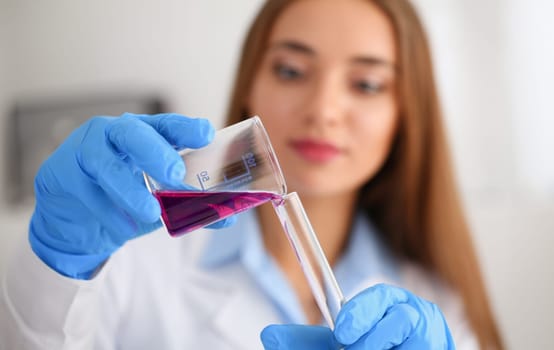 Technician hold in arms in protective gloves sample bottle with poison fluid portrait. Medical worker in uniform use reagent tube for virus infection exam water biological toxic reaction drug creation