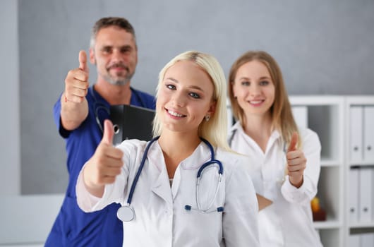 Group of doctor show ok or confirm sign with thumb up portrait. High level therapy great heal participation healthy lifestyle satisfied patient therapeutist arm best consultation physical