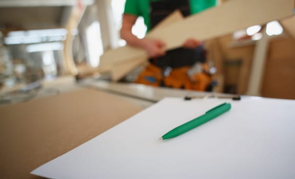 Drafting green pen lying on desk on clipboard pad closeup. Manual job DIY inspiration improvement fix shop hard hat joinery startup workplace idea designer career ruler industrial education