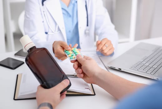 Alcoholic hold in arm empty bottle and medication at doctor reception office closeup. Grief and despair of intoxicated for sober life change drunkenness bad habit lifestyle dependence and temperance