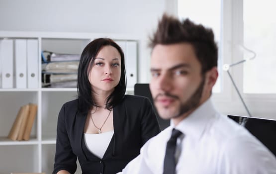 Portrait of pretty brunette woman and handsome man work at office businessmen