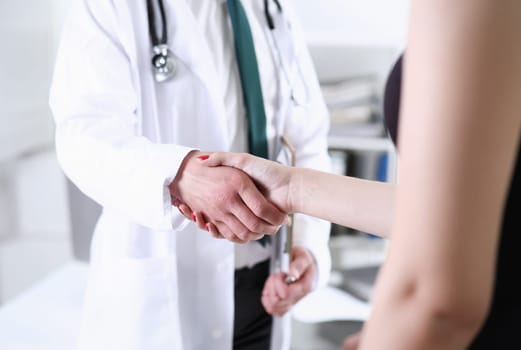 Doctor shake hand as hello with patient in office closeup. Welcoming friend introduction or thanks gesture consultation work thankful client talk team trust communication teamwork deal concept