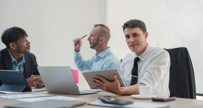 Business People Meeting using laptop computer,calculator,notebook,stock market chart paper for analysis Plans to improve quality next month. Conference Discussion Corporate Concept.