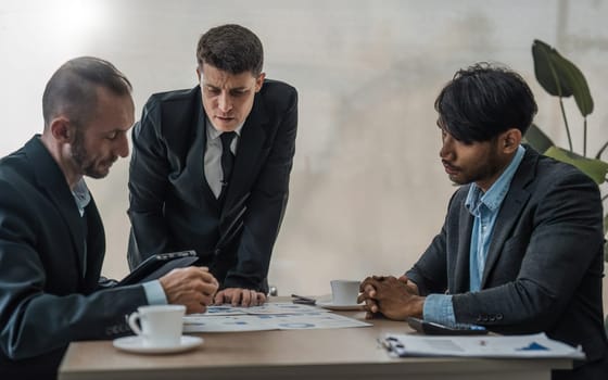 Business People Meeting using laptop computer,calculator,notebook,stock market chart paper for analysis Plans to improve quality next month. Conference Discussion Corporate Concept.