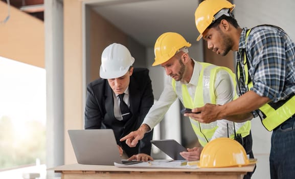 Diverse Team of Specialists Use Laptop on Construction Site. Real Estate Building Project with Engineer Investor and Businessman Checking Area, working on Civil Engineering, Discussing Strategy Plan.