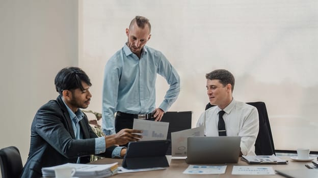 Business People Meeting using laptop computer,calculator,notebook,stock market chart paper for analysis Plans to improve quality next month. Conference Discussion Corporate Concept.