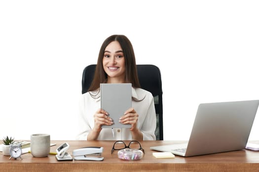 beautiful smiling female manager holding notebook in the office