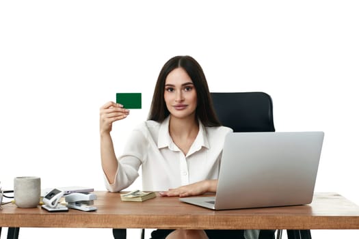 beautiful businesswoman holding plastic credit card in office