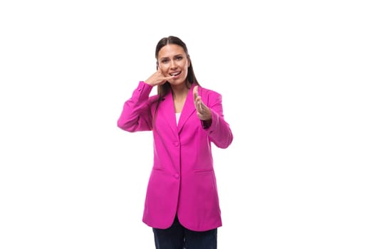 young cute business assistant woman dressed in a bright pink jacket on a white background with copy space.