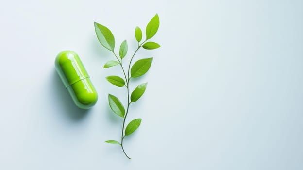 Green pill and fresh green leafy branch on light blue background. Natural medicine concept.