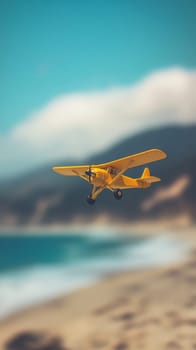 Yellow toy airplane flying over sandy beach with ocean and mountains in background, travel adventure and freedom concept.