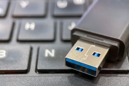 USB 3.0 Flash Drive Close-up. Metal connector and black case details of a USB 3.0 flash drive. This image is perfect for explaining data transfer, portable storage solutions and modern technology concepts.