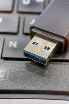 USB 3.0 Flash Drive Close-up. Metal connector and black case details of a USB 3.0 flash drive. This image is perfect for explaining data transfer, portable storage solutions and modern technology concepts.