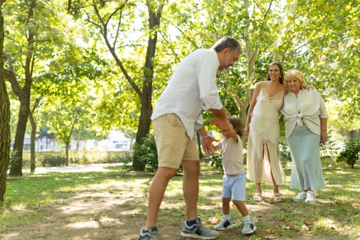 Multigenerational family is spending time together in a park on a sunny day