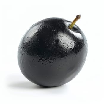 A ripe, glossy black olive with water droplets, isolated on a white background