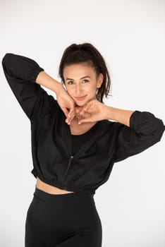 Young athlete girl posing in a black leggings and shirt. indoors.