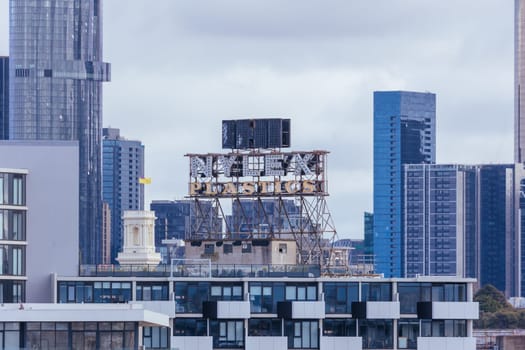 MELBOURNE, AUSTRALIA - JUNE 10, 2022: View towards Melbourne skyline and the iconic Nylex Clock sign from a high rise building in Cremorne in Australia