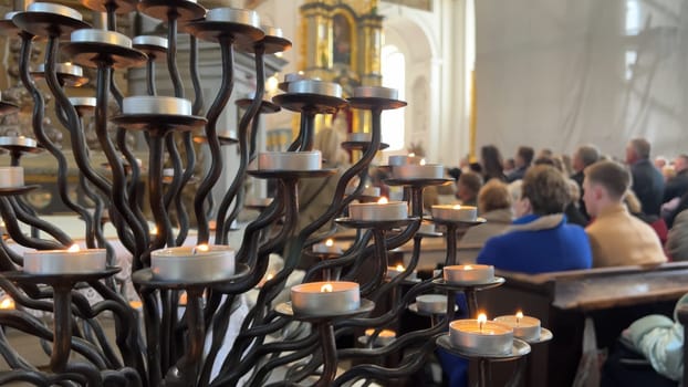 Burning candles in a Catholic church during the Divine Service