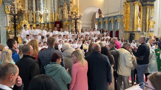 A photo session of children after their first communion in a Catholic church.