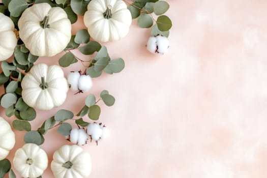 A collection of white pumpkins alongside cotton bolls and green leaves create a serene autumn display on a pastel background, ideal for seasonal decor inspirations.