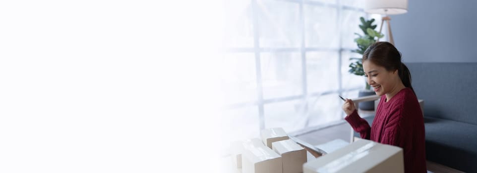 woman, online seller, Achieves sales success happiness using a tablet computer, goals, and drive success in her e-commerce business.
