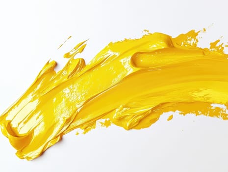 Vibrant yellow paint stroke on white background for creative design projects.