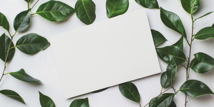 Elegant mockup card with green leaves on white table - perfect for wedding or birthday celebrations.