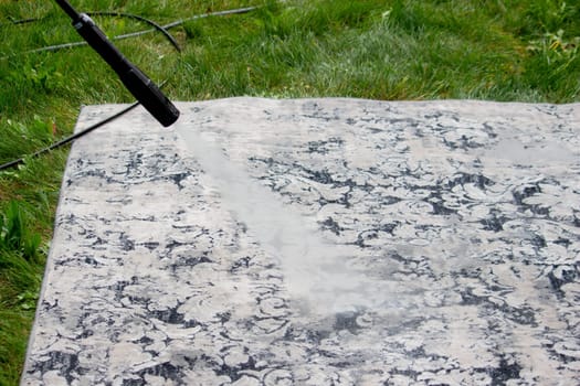 washing the carpet with a high pressure washer. Selective focus.