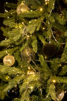 Balls on the Christmas tree close-up. Christmas tree design decorations. The concept of celebrating New Year and Christmas