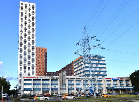 Moscow, Russia - Aug 3. 2024. Cityscape with the Vodnyy interior center, residential buildings and high-voltage power line