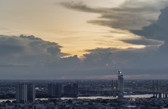 Bangkok, Thailand - 22 Aug 2024 - Beautiful skyscrapers view and the Bridge crosses the Chao Phraya river of Bangkok city with Dramatic sky background at before sunset. use it as your wallpaper, poster and banner design, Selective focus.