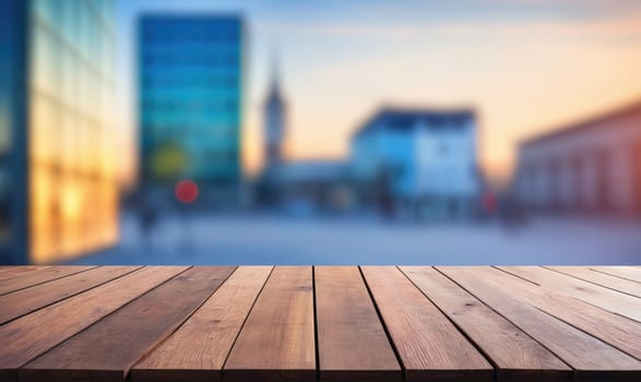 A wooden table with a light brown finish is positioned in the foreground with a blurred city skyline in the background. The city skyline is illuminated by a soft, warm light that suggests dusk.