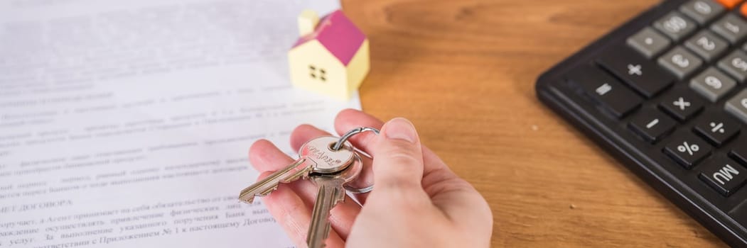 Real estate agent handed over the key to new home, marking a successful investment in business of property