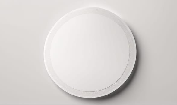 A close-up shot of a circular white ceiling light fixture with a subtle ring detail. The fixture is mounted on a white ceiling.