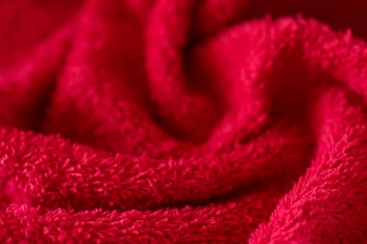 Weaving design with wavy shapes.Vibrant red background of textured fabric .Wallpeper.Space for copy. Decorative background for or product advertisement.