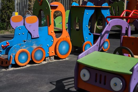 Wooden cars on the children playground. Children's games on the street. Leisure. area at kindergarten