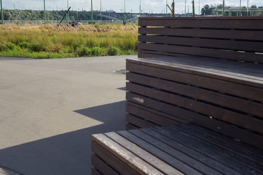 Wooden benches for sitting .An outdoor area of the park where visitors can relax and admire nature