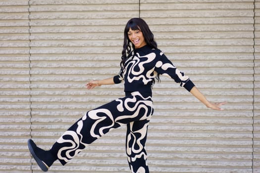 Energetic hispanic beauty female dancer performing a choreography in the city
