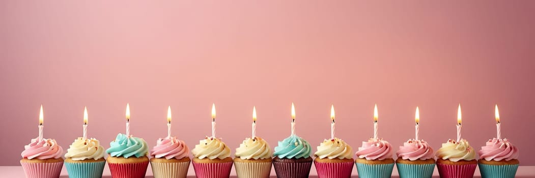 Colorful cupcakes with lit candles are displayed against a pink background, indicating an indoor celebration event marking of joy and celebrating. with free space.