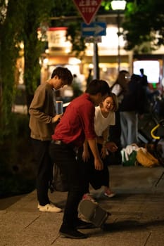 KYOTO, JAPAN - MAY 18: Local kids skateboard on the streets at night in Kyoto, Japan
