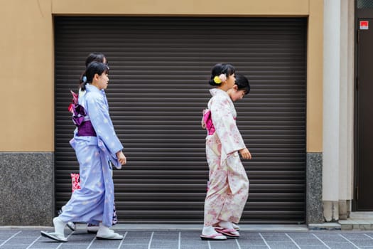 KYOTO, JAPAN - MAY 14, 2019: Young ladies in a kimono in the streets of Kyoto on a warm spring day in Japan