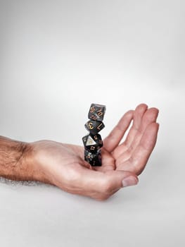 Balancing polyhedral dice in hand: precision and gaming aesthetics.