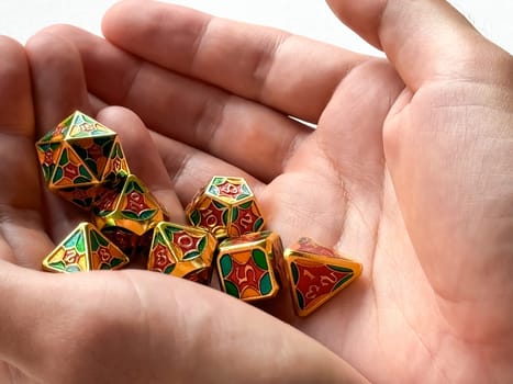 Colorful dungeons and dragons dice set held in hands for tabletop gaming enthusiasts.